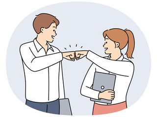 Smiling businesspeople give fists bump