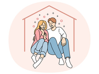 Happy couple sits in imaginary house dreaming of mortgage and buying own property or renting large apartment. Man and woman hugging inside house, using services of real estate insurance