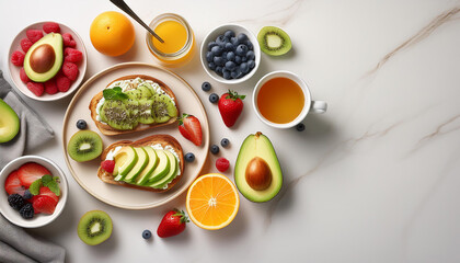 Top-down view of a healthy breakfast table, including avocado toast, fresh fruits, a smoothie bowl