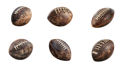 Multiple American footballs, worn and weathered, are displayed in various angles and orientations.
