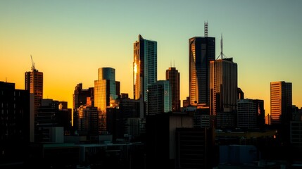 Obraz premium A cityscape at dawn, with the first light of day casting a golden hue on the tops of the tallest buildings in the city center.