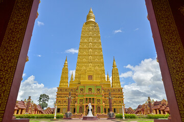 Wat Mahathat Wachiramongkhon or Wat Bang Thong, Krabi Province, Thailand. Beautiful scenery of a great golden pagoda in buddhist temple with cloudy blue sky under sunlight.
