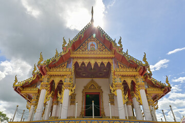 Wat Mahathat Wachiramongkhon or Wat Bang Thong, Krabi Province, Thailand. Beautiful chapel in buddhist temple with cloudy blue sky under sunlight.