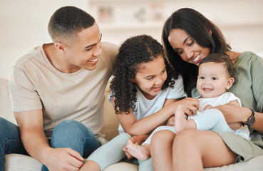 Happy, love and parents with baby and child in home for bonding, connection or family time. Smile, fun and young mother and father holding infant with girl kid sibling in living room at house.