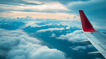 Naklejka premium The view from an airplane reveals a breathtaking panorama of clouds and mountains.