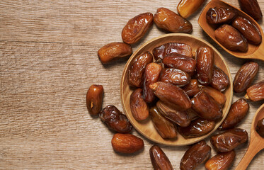 top view flat lay dry date palm fruit in wood bowl food background with copy space