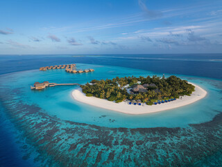 An aerial photograph of a beautiful paradise-like tropical beach on an island in the Maldives