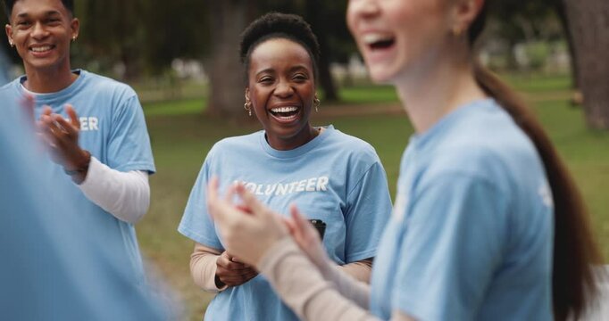Woman, volunteer and outdoor together for applause, success and charity event with goals for change. People, diversity and scrum with cheers, happy and solidarity for social responsibility in park