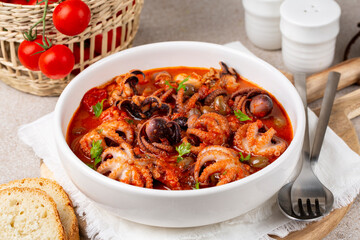 Italian or Greek-style braised baby octopus stew with tomato sauce, garlic and olives.