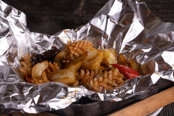 Chinese Beef Stir Fry on Iron Plate on a wooden background. Food concept. Chinese food.