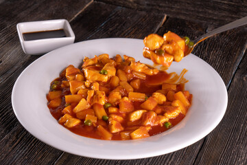 Chinese Pineapple Chicken on a wooden background. Food concept. Chinese food.