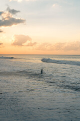 Fototapeta premium People running on the beach in Bali, Indonesia at sunrise