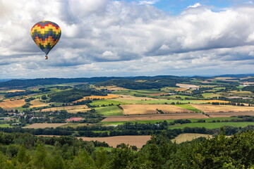 Fototapeta premium Hot air balloons fly over European landscape