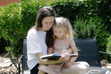 Woman and a child learning in the backyard