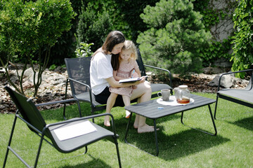 Woman and a child learning in the backyard