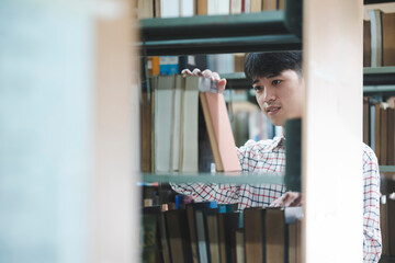 Man Searching for a Book in the Library