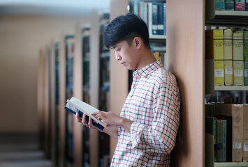University Student Reading Book in Library
