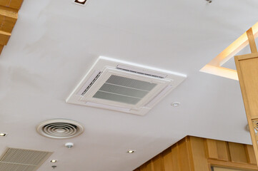 Ceiling mounted air conditioning unit in modern interior space