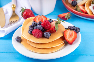 Stack of traditional american pancakes with summer berries