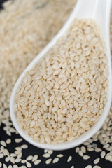 White roasted sesame seeds in a spoon