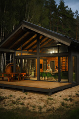 A view from outside at the couple sitting behind dining table in modern cabin in the evening