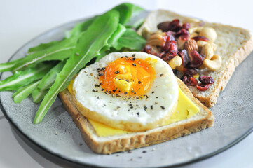 bread with egg and cheese topping or  sunny side up egg , lettuce and almond with dried cranberry