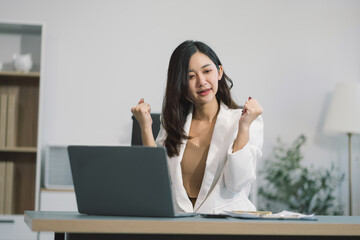 successful business women hand working with tablet and laptop computer with documents on office desk in modern office.