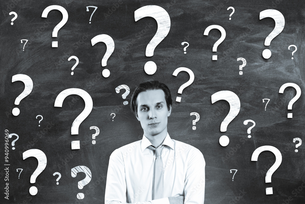 Aufkleber portrait of attractive young businessman on chalkboard wall background with question marks. solution