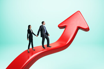 Obraz premium Young businesswoman and man standing on upward red arrow. Blue background. Growth and success concept.