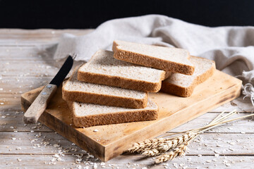 Healthy wholemeal bread slices on rustic wooden table