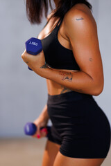 CLose up of sporty woman hands with dumbbells