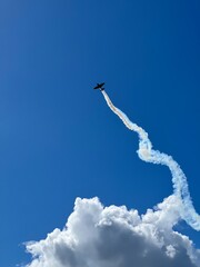 Plane is flying on a blue sky up in Lithuania