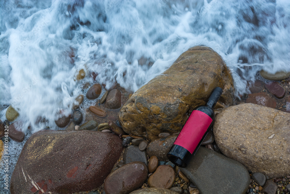 Wall mural Bottle of wine by the sea