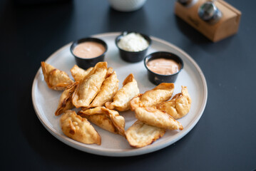 Fried dumplings on black table grille