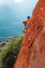 sport in summer camp. a child is rock climbing at a summer camp. rock climber boy. sport in nature...