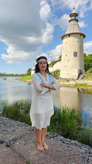 Beautiful girl in a Russian shirt near the Kremlin. Pskov