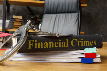 Book financial crimes with handcuffs on it. Legal consequences and economic fraud.
