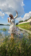Beautiful girl in a Russian shirt near the Kremlin. Pskov
