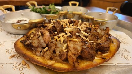 Sumac-Spiced Chicken Mssakhan – Tender Chicken Thighs with Caramelized Onions, Nuts, and Warm Flatbread