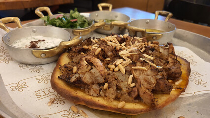 Sumac-Spiced Chicken Mssakhan – Tender Chicken Thighs with Caramelized Onions, Nuts, and Warm Flatbread