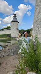 Beautiful girl in a Russian shirt near the Kremlin. Pskov