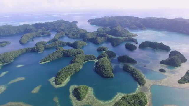 Aerial View Of Koror Island. Many Green Islets. Palau Seascape With Colorful Coral Reefs And Tropical Lagoons. Cityscape in Background. Drone.