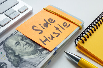 Stack of money labeled side hustle. Additional income and entrepreneurial ventures.