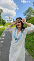 Beautiful girl in a Russian shirt near the Kremlin. Pskov