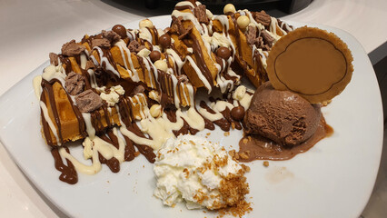Belgian Waffle with White and Dark Chocolate, Ice Cream, Whipped Cream, and Chocolate Balls – A Decadent Dessert Delight