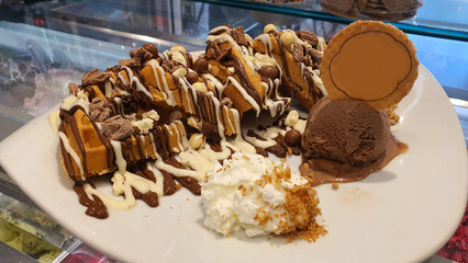 Belgian Waffle with White and Dark Chocolate, Ice Cream, Whipped Cream, and Chocolate Balls – A Decadent Dessert Delight