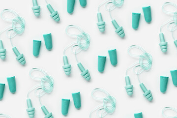 Colored earplugs as minimal trend pattern, reusable silicone and rubber ear plug on cord against...