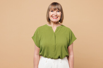 Elderly smiling happy cheerful optimist blonde woman 50s years old she wear green shirt casual...