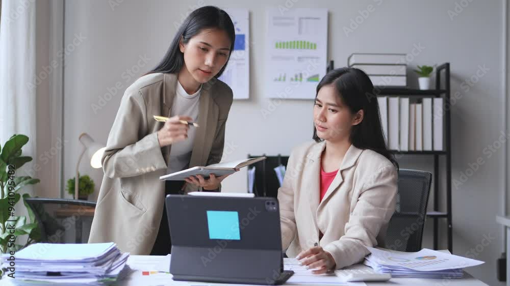 Poster two businesswomen discussing work while analyzing charts and financial data on a laptop. collaborati