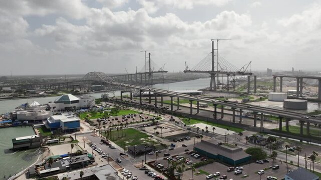 Corpus Christi, TX, USA, aerial video view of area around Texas State Aquarium, Harbor Bridge  and construction site of "New Harbor Bridge" aka as "US 181 Harbor Bridge" a Cable-stayed bridge